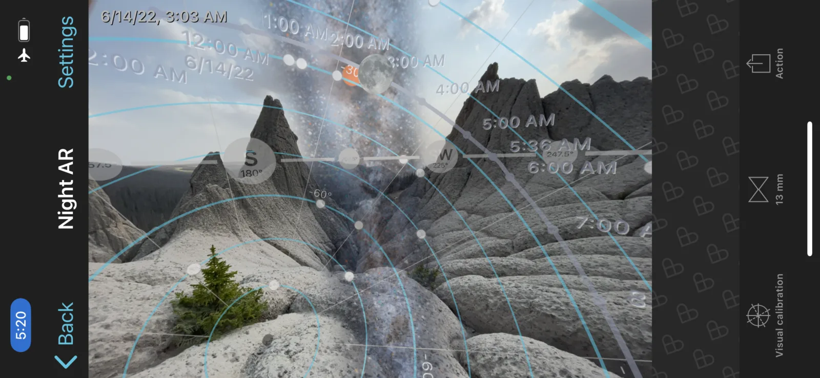 PhotoPills augmented reality app view showing Milky Way alignment over a mountain landscape